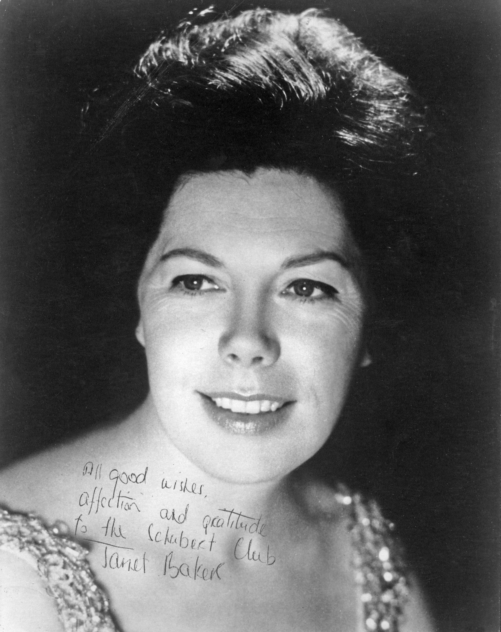 signed black and white photograph of Janet Baker smiling and looking slightly off-camera
